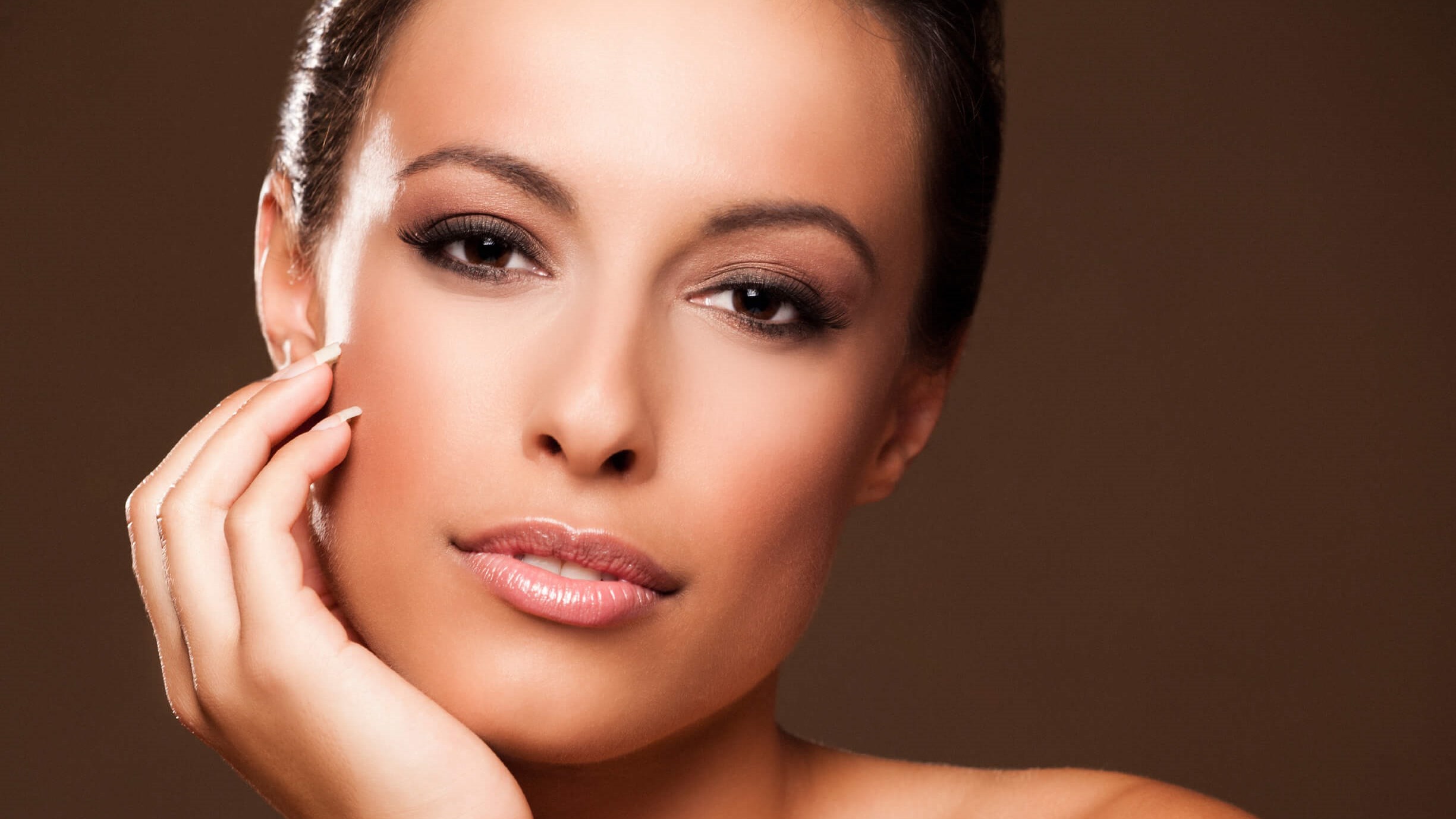 woman posing hand on her face